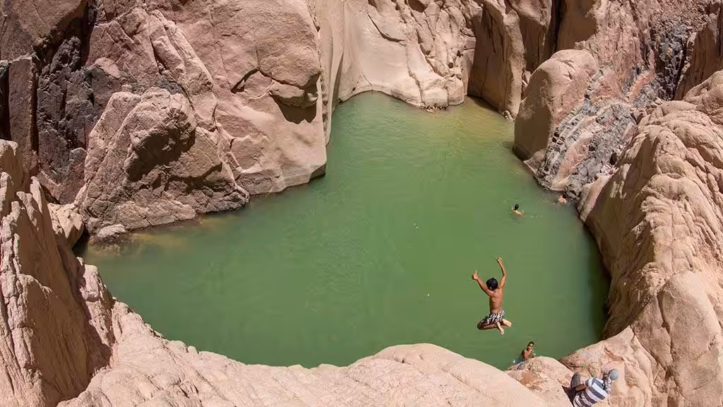 Wadi El Weshwash green lake surrounded by mountains