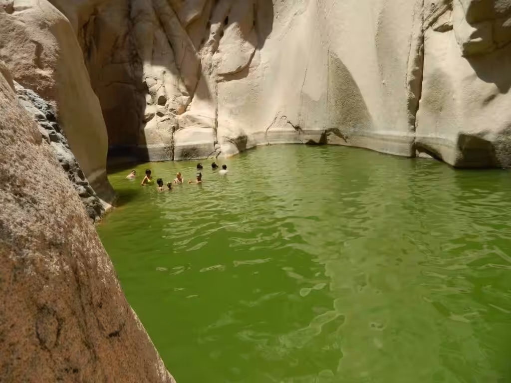 Wadi El Weshwash green lake surrounded by mountains