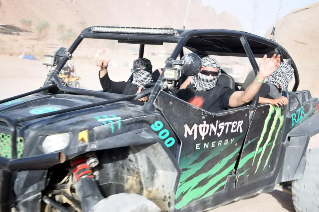 Family enjoying a desert safari in a secure dune buggy with Kimidar Tours.