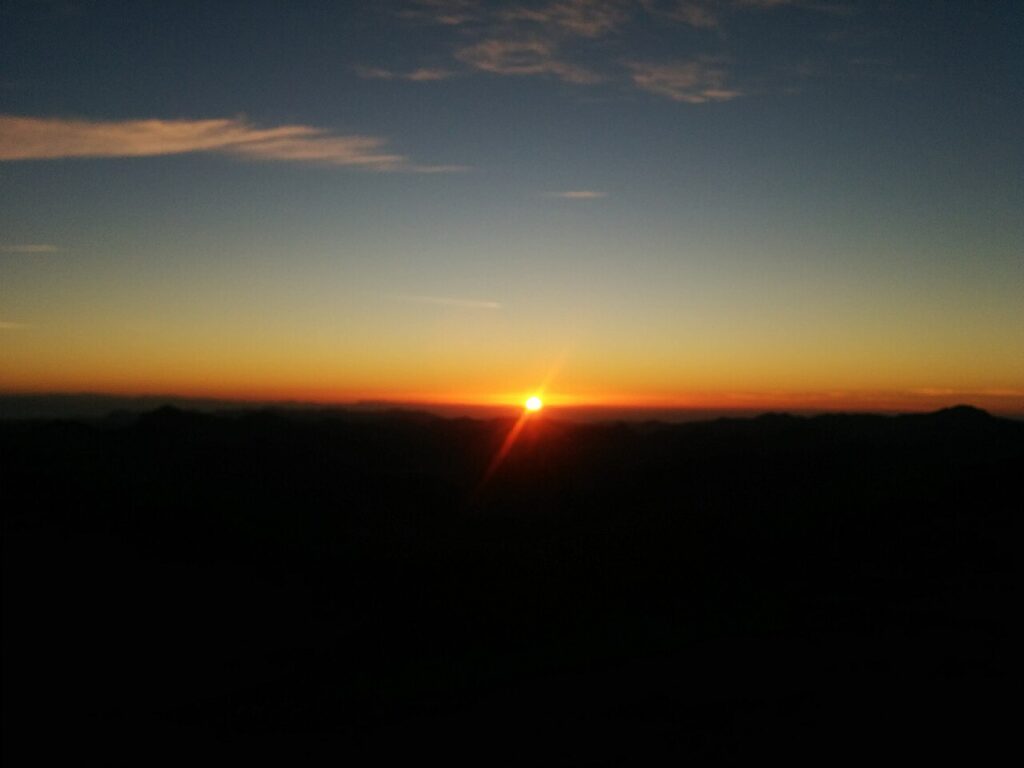 Sunrise from Mount Sinai summit over Sinai mountains in Egypt