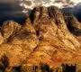 Alt Text: Mount Sinai Egypt at sunrise with hikers overlooking the Sinai Mountains