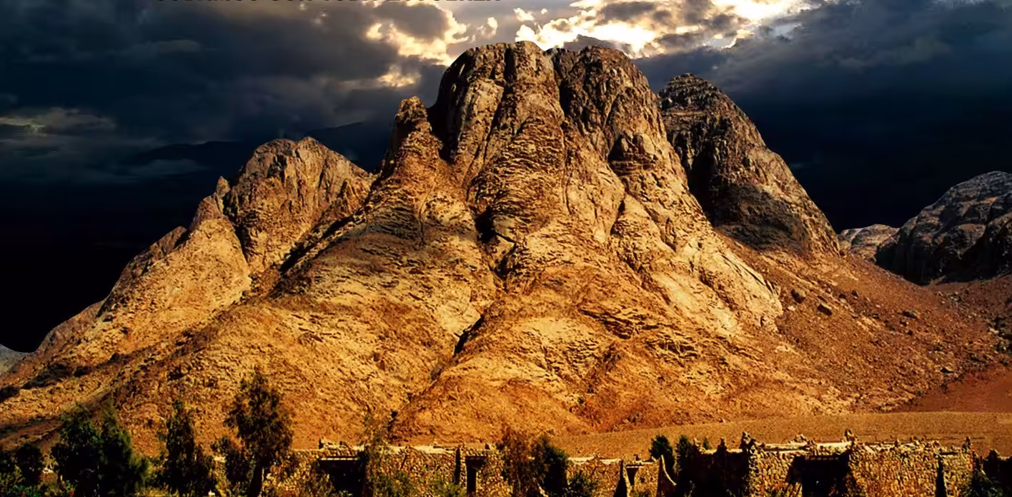 Alt Text: Mount Sinai Egypt at sunrise with hikers overlooking the Sinai Mountains